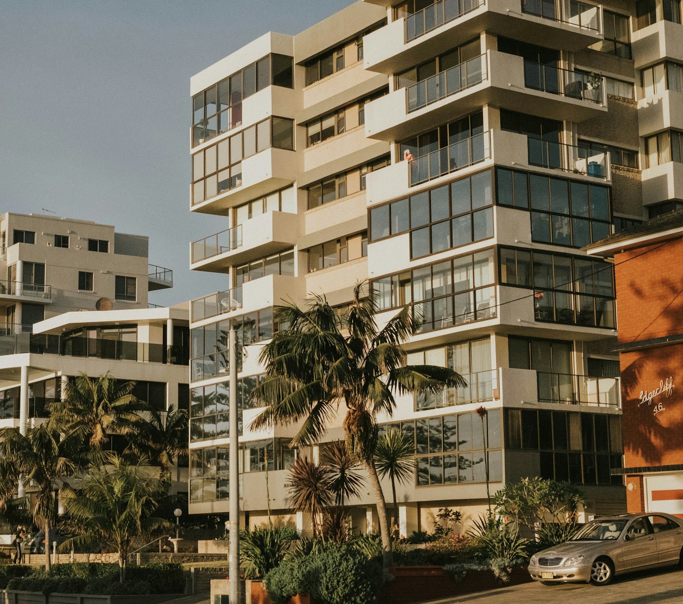 Modern residential complex surrounded by palm trees